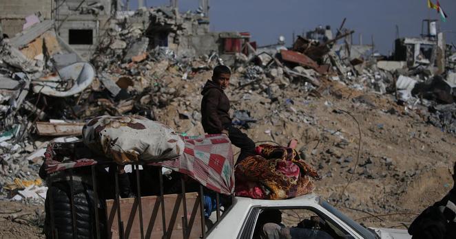 A family travels through Rafah in the southern Gaza Strip in a vehicle packed with their belongings.